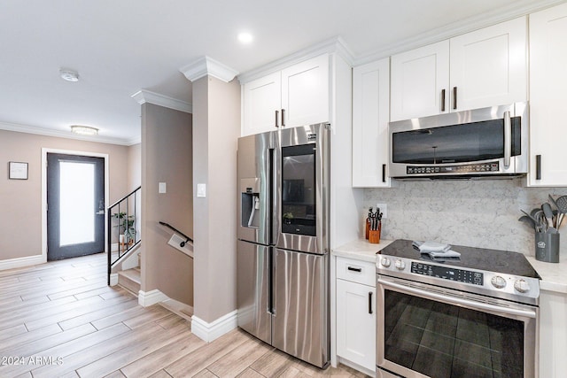 kitchen with stainless steel appliances, white cabinetry, crown molding, and decorative backsplash