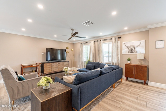 living area featuring ornamental molding, light wood-type flooring, visible vents, and baseboards