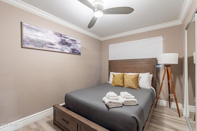 bedroom with ornamental molding, light wood-style flooring, and baseboards