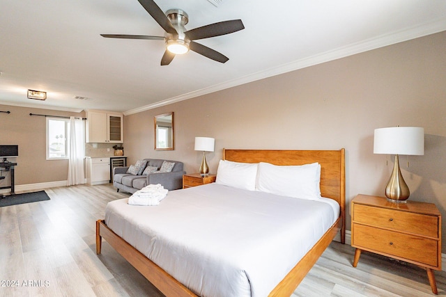 bedroom featuring baseboards, ornamental molding, a ceiling fan, and light wood-style floors