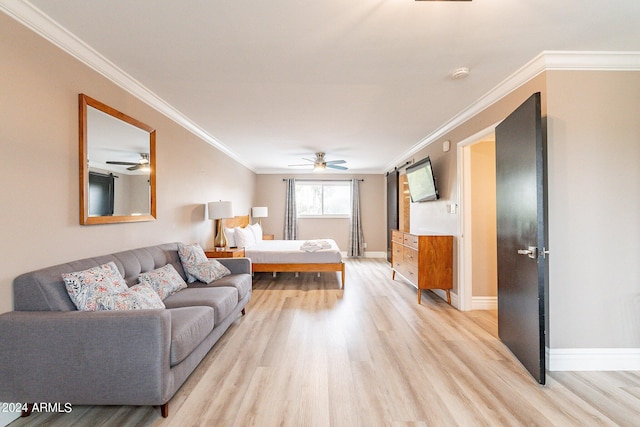 bedroom with a ceiling fan, light wood-style flooring, baseboards, and crown molding