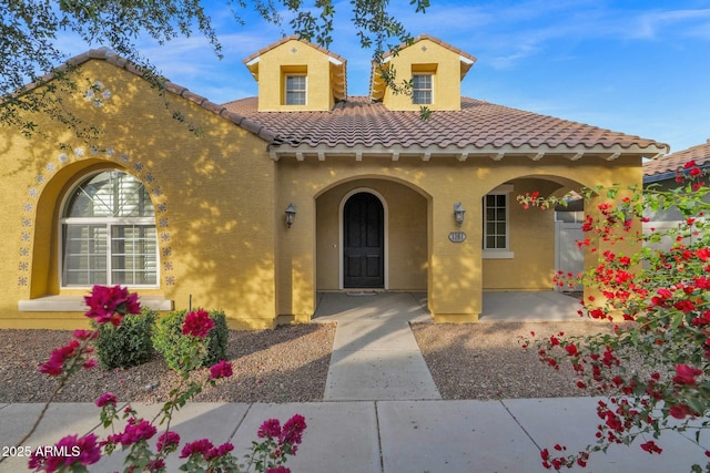 1161 S Storment Ln, Gilbert, AZ 85296 - view of front of property with covered porch, a tile roof, and stucco siding