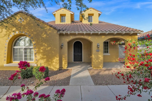 mediterranean / spanish-style home featuring covered porch