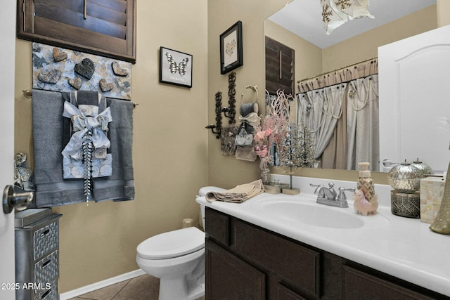 bathroom with tile patterned flooring, vanity, and toilet