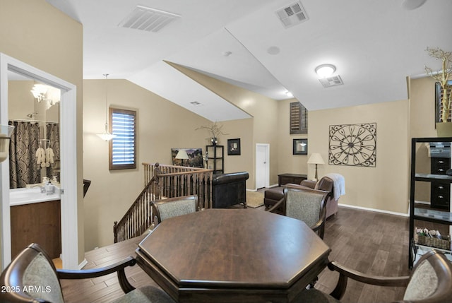 dining room featuring lofted ceiling and dark hardwood / wood-style floors