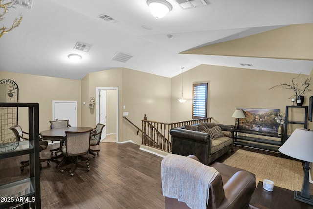 living room featuring vaulted ceiling and dark hardwood / wood-style floors