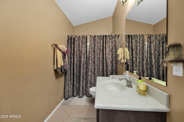 bathroom featuring tile patterned flooring, vanity, lofted ceiling, and toilet