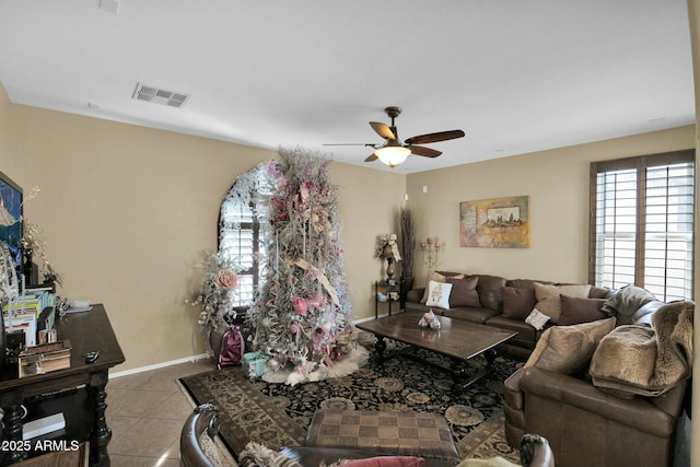 living room featuring light tile patterned floors and ceiling fan