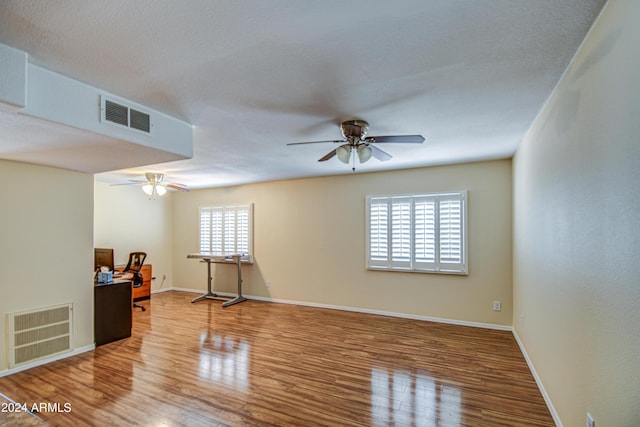 spare room with wood-type flooring and ceiling fan