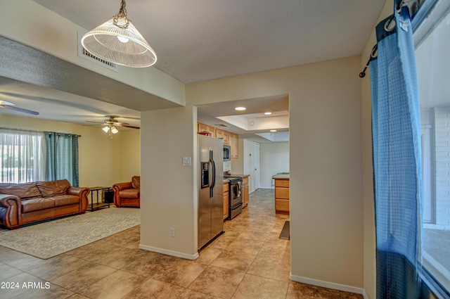 interior space featuring light tile patterned floors and ceiling fan