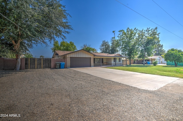 ranch-style home with a garage and a front lawn