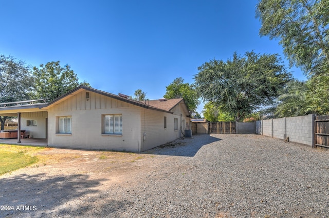 view of property exterior featuring a jacuzzi, central AC unit, and a patio area