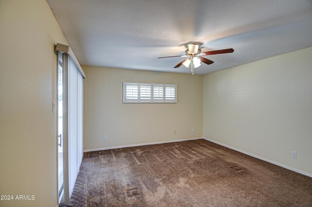 carpeted empty room with a textured ceiling and ceiling fan