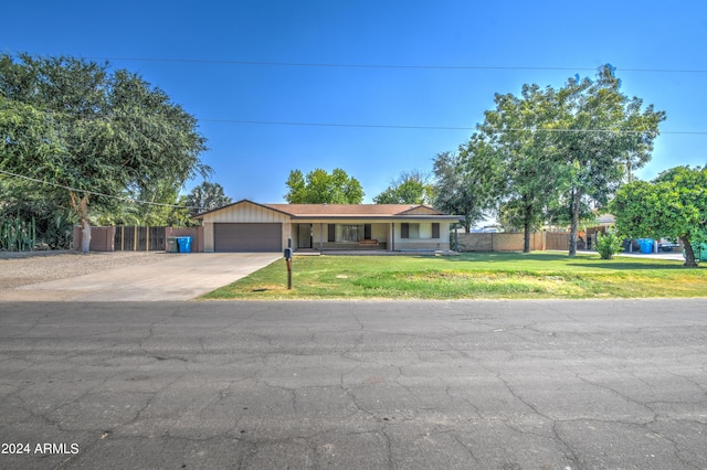 single story home with a garage and a front lawn