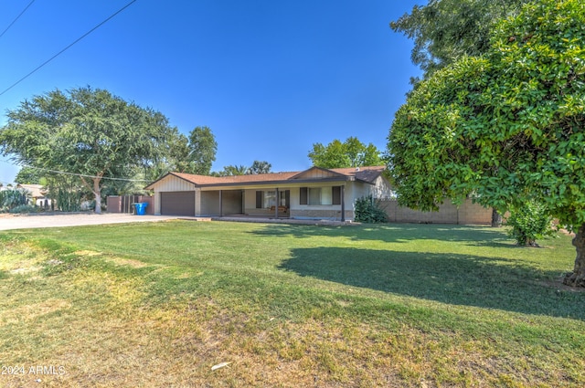 ranch-style home with a garage and a front lawn