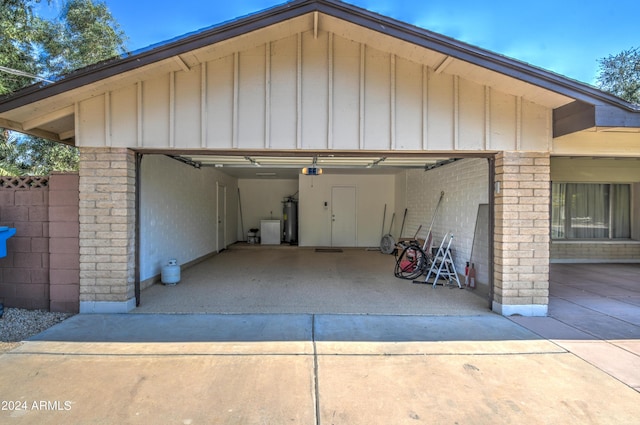 garage with a garage door opener and electric water heater