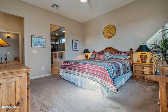 bedroom with visible vents, baseboards, carpet, and ensuite bath