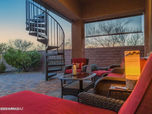 view of patio with stairs and fence