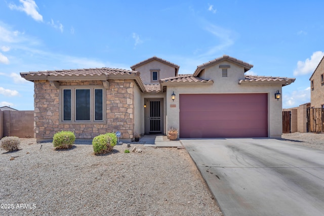 23886 W Harrison Dr, Buckeye, AZ 85326 - mediterranean / spanish home with driveway, an attached garage, stucco siding, and a tile roof