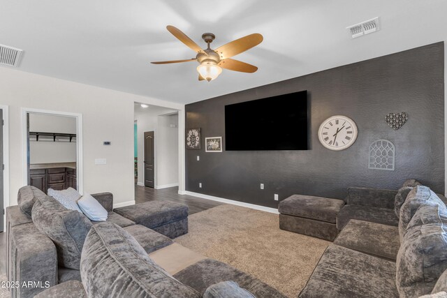 23886 W Harrison Dr, Buckeye, AZ 85326 - living room with a ceiling fan, an accent wall, and wood finished floors