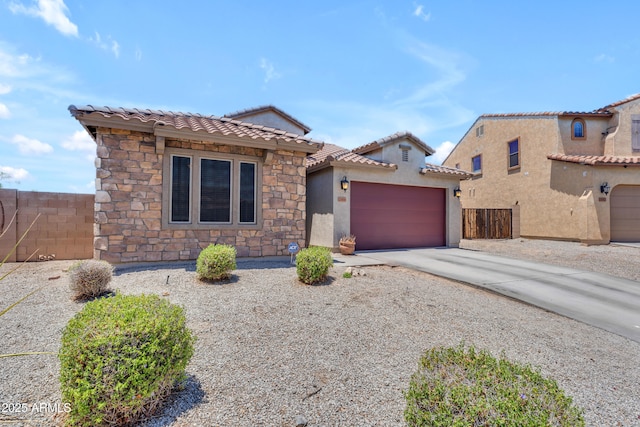 23886 W Harrison Dr, Buckeye, AZ 85326 - view of front of house featuring driveway, a garage, a tile roof, stucco siding, and stone siding