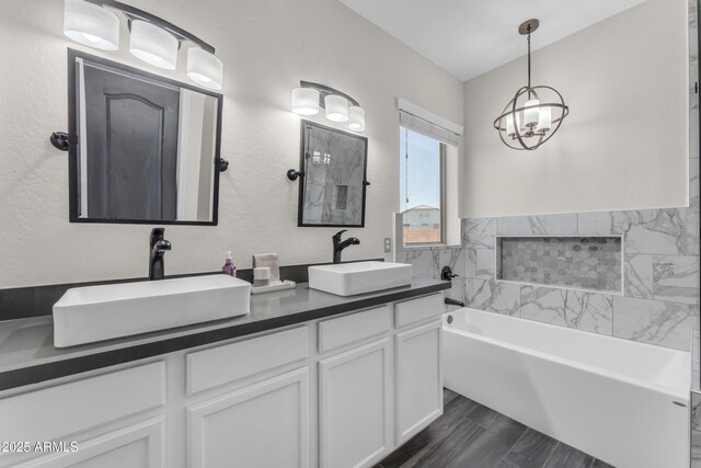 23886 W Harrison Dr, Buckeye, AZ 85326 - bathroom with a chandelier, a garden tub, double vanity, and wood finished floors