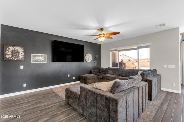 23886 W Harrison Dr, Buckeye, AZ 85326 - living area featuring an accent wall, a ceiling fan, and wood finished floors