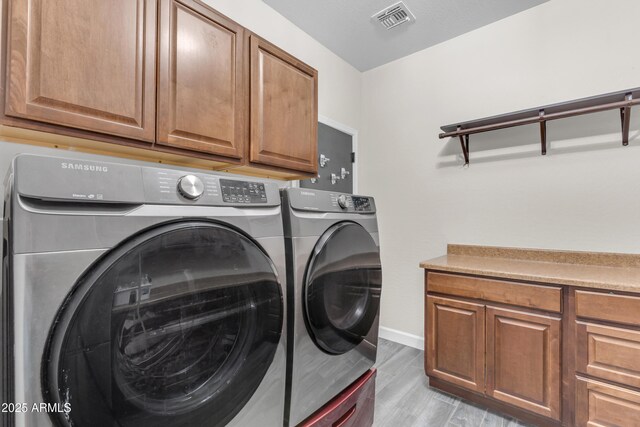23886 W Harrison Dr, Buckeye, AZ 85326 - laundry area featuring cabinet space, separate washer and dryer, and light wood finished floors