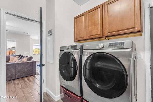 23886 W Harrison Dr, Buckeye, AZ 85326 - laundry area with cabinet space, separate washer and dryer, and light wood-type flooring