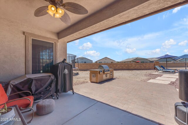 23886 W Harrison Dr, Buckeye, AZ 85326 - fenced backyard featuring a patio, ceiling fan, and area for grilling