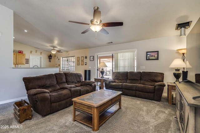 living room with light colored carpet, vaulted ceiling, visible vents, and plenty of natural light