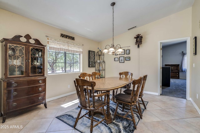 dining area featuring light tile patterned floors, lofted ceiling, a chandelier, visible vents, and baseboards