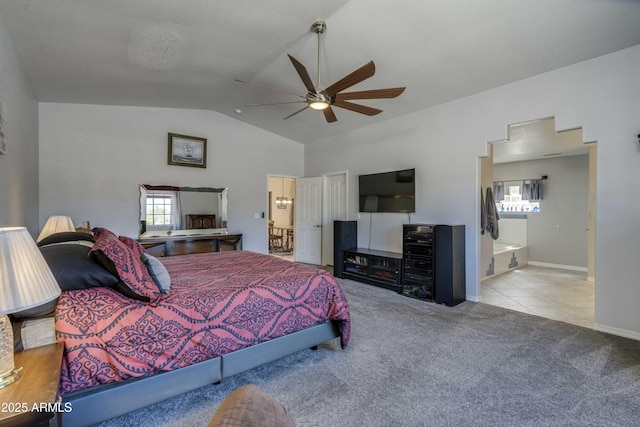 bedroom with light colored carpet, ensuite bathroom, a ceiling fan, vaulted ceiling, and baseboards