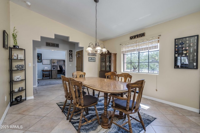 dining room featuring vaulted ceiling, light tile patterned floors, baseboards, and an inviting chandelier