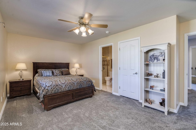 bedroom with carpet floors, a ceiling fan, baseboards, and ensuite bathroom