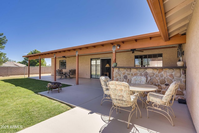 view of patio / terrace featuring a ceiling fan, outdoor dining space, and fence