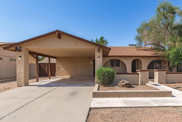 7340 W Meadowbrook Ave, Phoenix, AZ 85033 - view of front facade featuring driveway, stucco siding, a carport, and roof with shingles