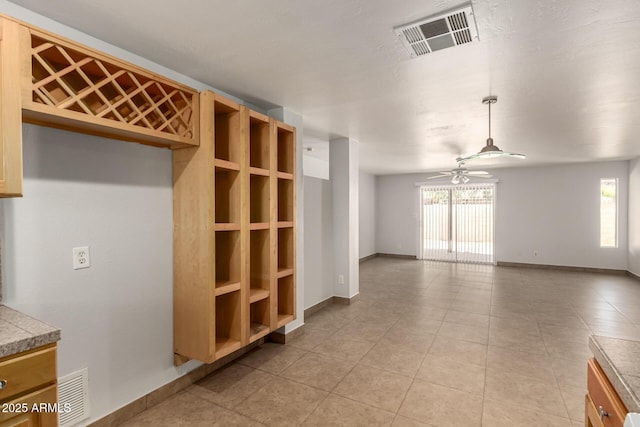 7340 W Meadowbrook Ave, Phoenix, AZ 85033 - unfurnished living room featuring a ceiling fan, light tile patterned floors, and baseboards