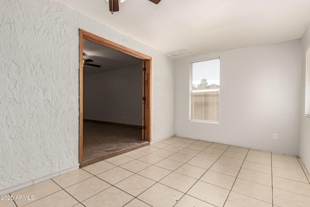 7340 W Meadowbrook Ave, Phoenix, AZ 85033 - spare room with a textured wall, a ceiling fan, and light tile patterned flooring