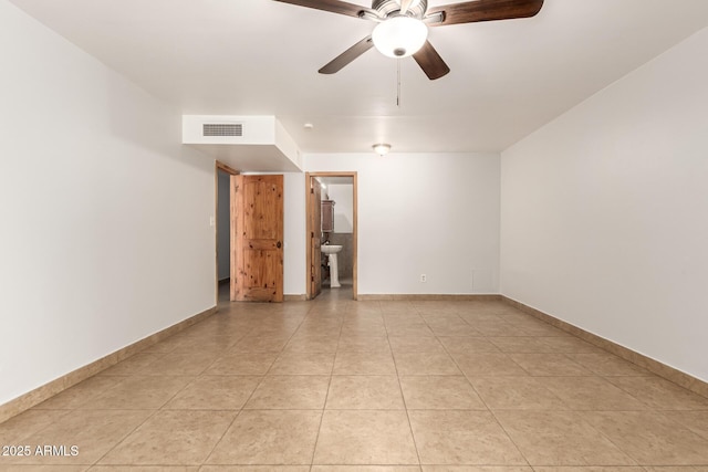 7340 W Meadowbrook Ave, Phoenix, AZ 85033 - empty room featuring ceiling fan, light tile patterned floors, and baseboards