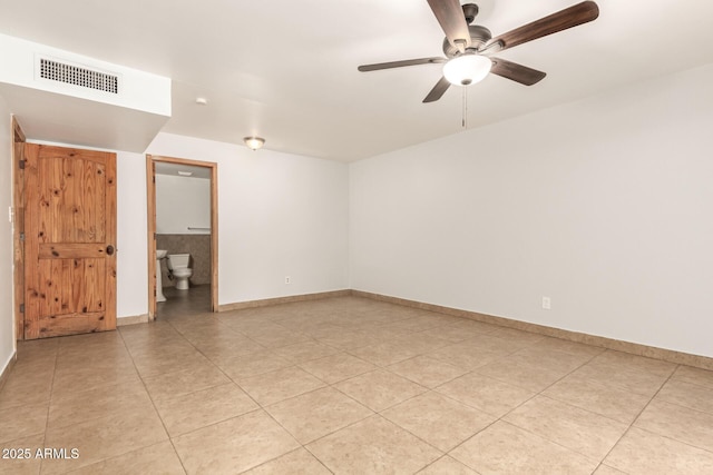 7340 W Meadowbrook Ave, Phoenix, AZ 85033 - empty room featuring a ceiling fan, light tile patterned flooring, and baseboards