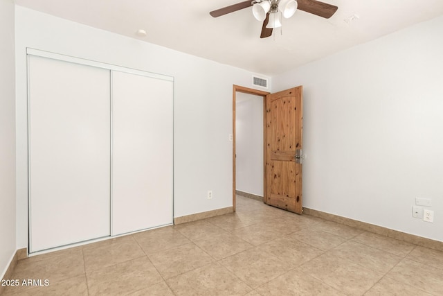 7340 W Meadowbrook Ave, Phoenix, AZ 85033 - unfurnished bedroom featuring baseboards, a closet, a ceiling fan, and light tile patterned floors