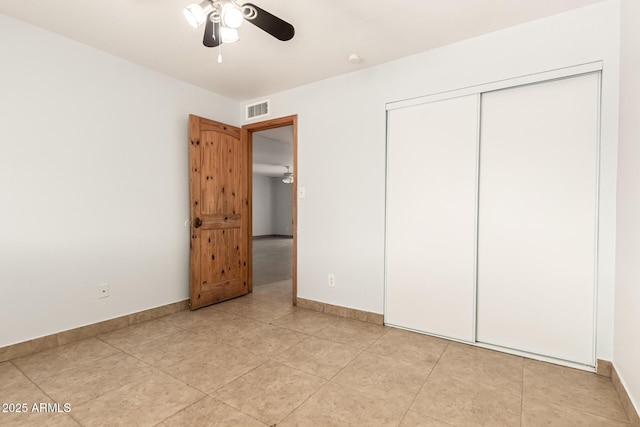 7340 W Meadowbrook Ave, Phoenix, AZ 85033 - unfurnished bedroom featuring baseboards, a closet, light tile patterned flooring, and ceiling fan