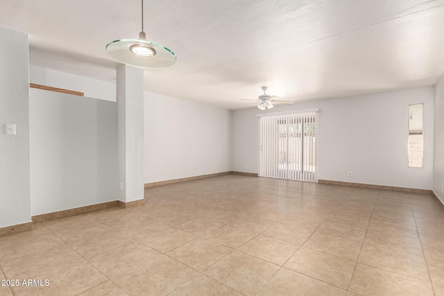 7340 W Meadowbrook Ave, Phoenix, AZ 85033 - empty room with a ceiling fan, light tile patterned floors, and baseboards