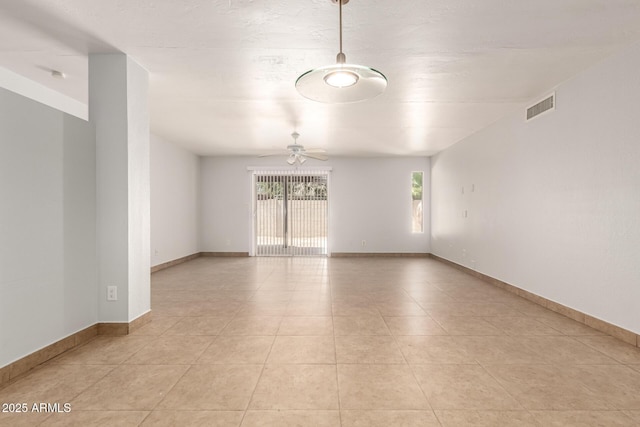 7340 W Meadowbrook Ave, Phoenix, AZ 85033 - empty room with ceiling fan, light tile patterned floors, and baseboards