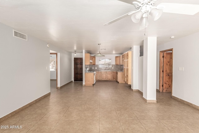 7340 W Meadowbrook Ave, Phoenix, AZ 85033 - unfurnished living room with a sink, a ceiling fan, baseboards, and light tile patterned floors