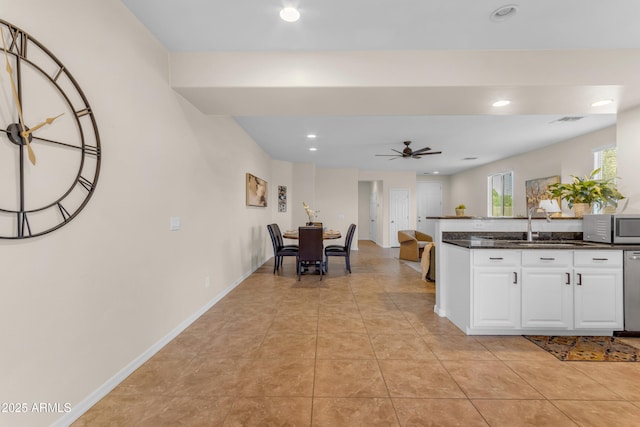 11159 E Sebring Ave, Mesa, AZ 85212 - kitchen featuring appliances with stainless steel finishes, ceiling fan, dark countertops, white cabinets, and recessed lighting