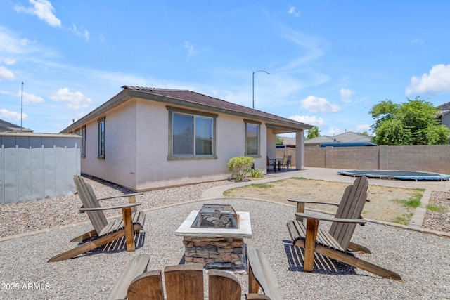 11159 E Sebring Ave, Mesa, AZ 85212 - rear view of property featuring an outdoor fire pit, stucco siding, a patio area, and a fenced backyard