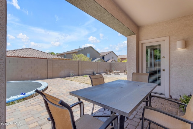 11159 E Sebring Ave, Mesa, AZ 85212 - fenced backyard with outdoor dining area, a patio, and a trampoline
