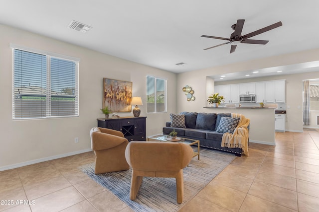 11159 E Sebring Ave, Mesa, AZ 85212 - living room featuring light tile patterned floors, ceiling fan, and recessed lighting